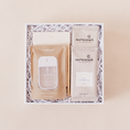 Load image into Gallery viewer, Desk essentials corporate gift box with Touchland Beach Coco hand sanitizer, notepad, gold pen, and two Moonstruck creamy milk chocolate hot cocoa packets in a white box with crinkle paper