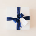 Load image into Gallery viewer, White gift box packaging tied with navy ribbon and tag