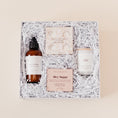 Load image into Gallery viewer, Lavender and Pine Self Care Sunday Gift Box featuring Roote oat and honey body lotion, Thulisa Naturals shower steamer discovery set, NCLA Beauty Hey Sugar coconut vanilla body scrub, and Roote Amber Noir candle in white luxe two piece gift box