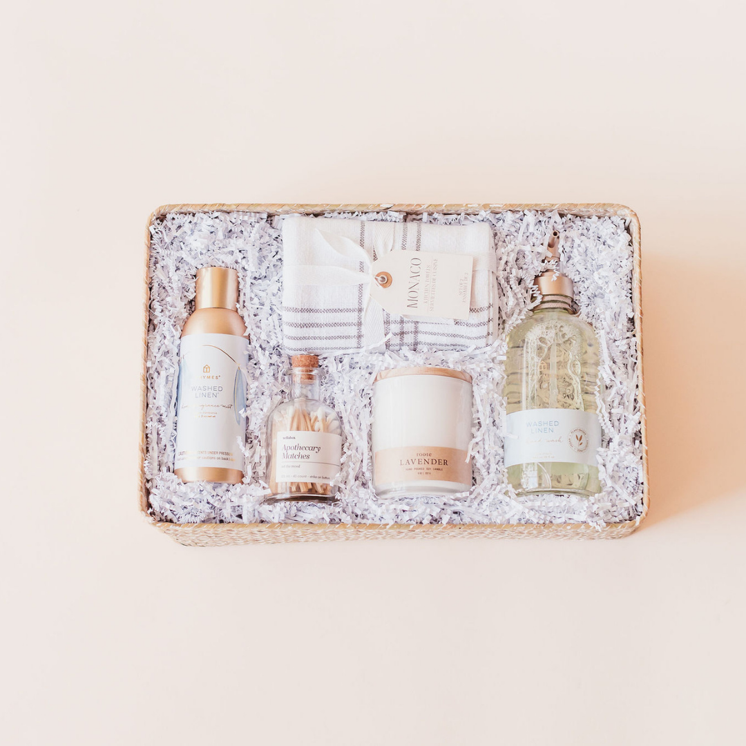 Luxury client gift box for wedding planners and photographers featuring lavender candle, linen towel, apothecary matches, and bath essentials in a woven basket – Lavender + Pine