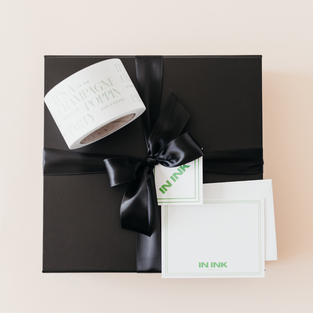 Black gift box with satin ribbon, custom branded shipping tape, and personalized notecards for a wedding planner client gifting program by Lavender and Pine