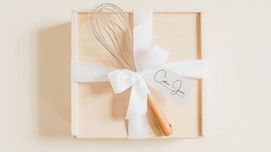 Luxury wooden gift box with white satin quad bow, custom branded tag, and whisk added - curated by Lavender + Pine