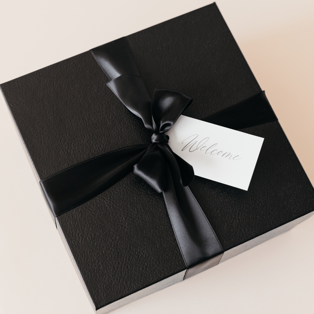 Luxury black corporate welcome gift box with satin ribbon and handwritten welcome card – Lavender + Pine custom event gifting