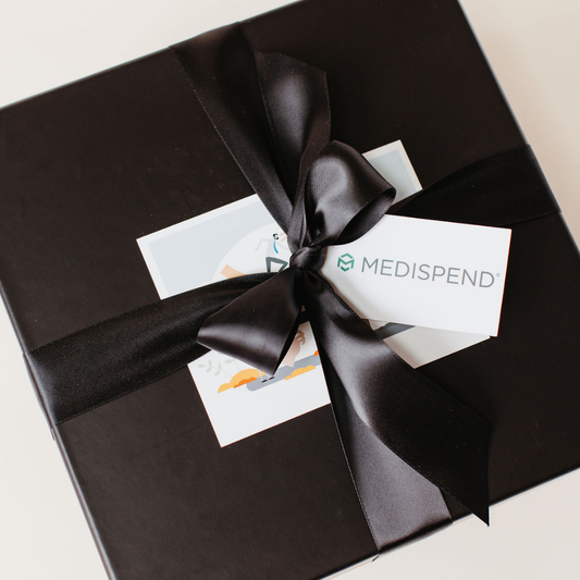 Branded black corporate gift box tied with a satin ribbon, featuring a Medispend logo card – luxury appreciation gift by Lavender + Pine