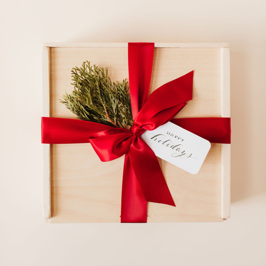 Luxury holiday gift box with red satin ribbon and evergreen sprig, custom holiday gifting by Lavender + Pine
