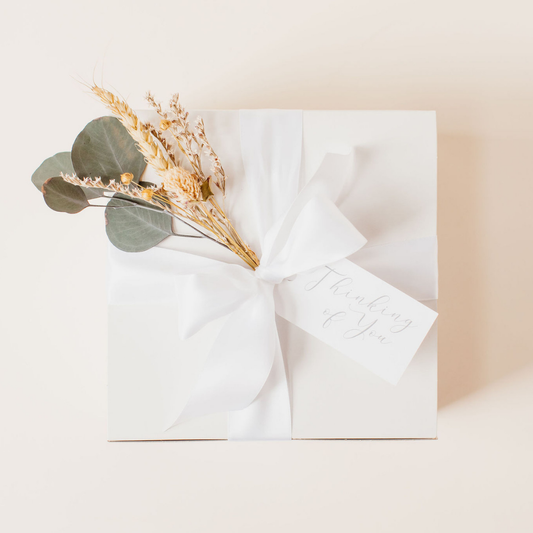 Elegant Galentine’s Day gift box with white ribbon and dried floral bundle by Lavender + Pine.