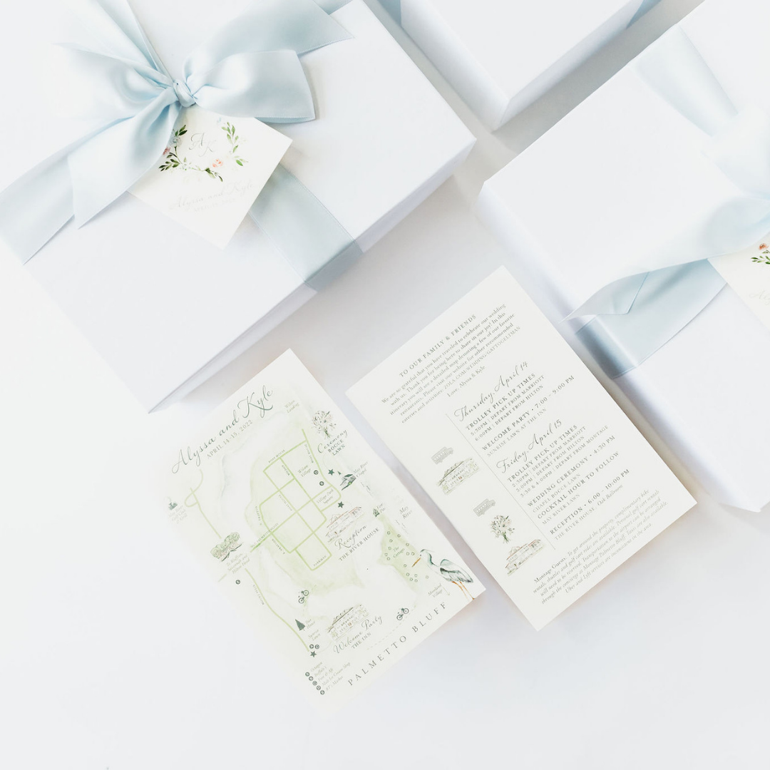 Custom white wedding welcome gift boxes with baby blue ribbon, watercolor itinerary, and venue map for Montage Palmetto Bluff wedding by Lavender + Pine.