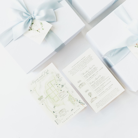 Custom white wedding welcome gift boxes with baby blue ribbon, watercolor itinerary, and venue map for Montage Palmetto Bluff wedding by Lavender + Pine.