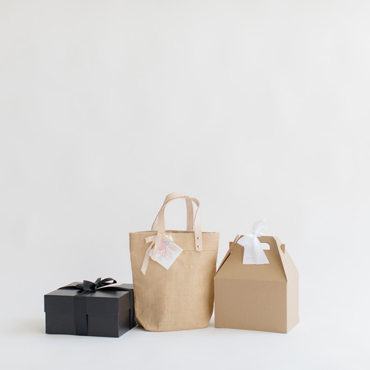 Three elegant wedding welcome gift packaging styles from Lavender + Pine, including a black gift box, a jute tote with leather handles, and a kraft gable box-perfect for Mystic, CT weddings.