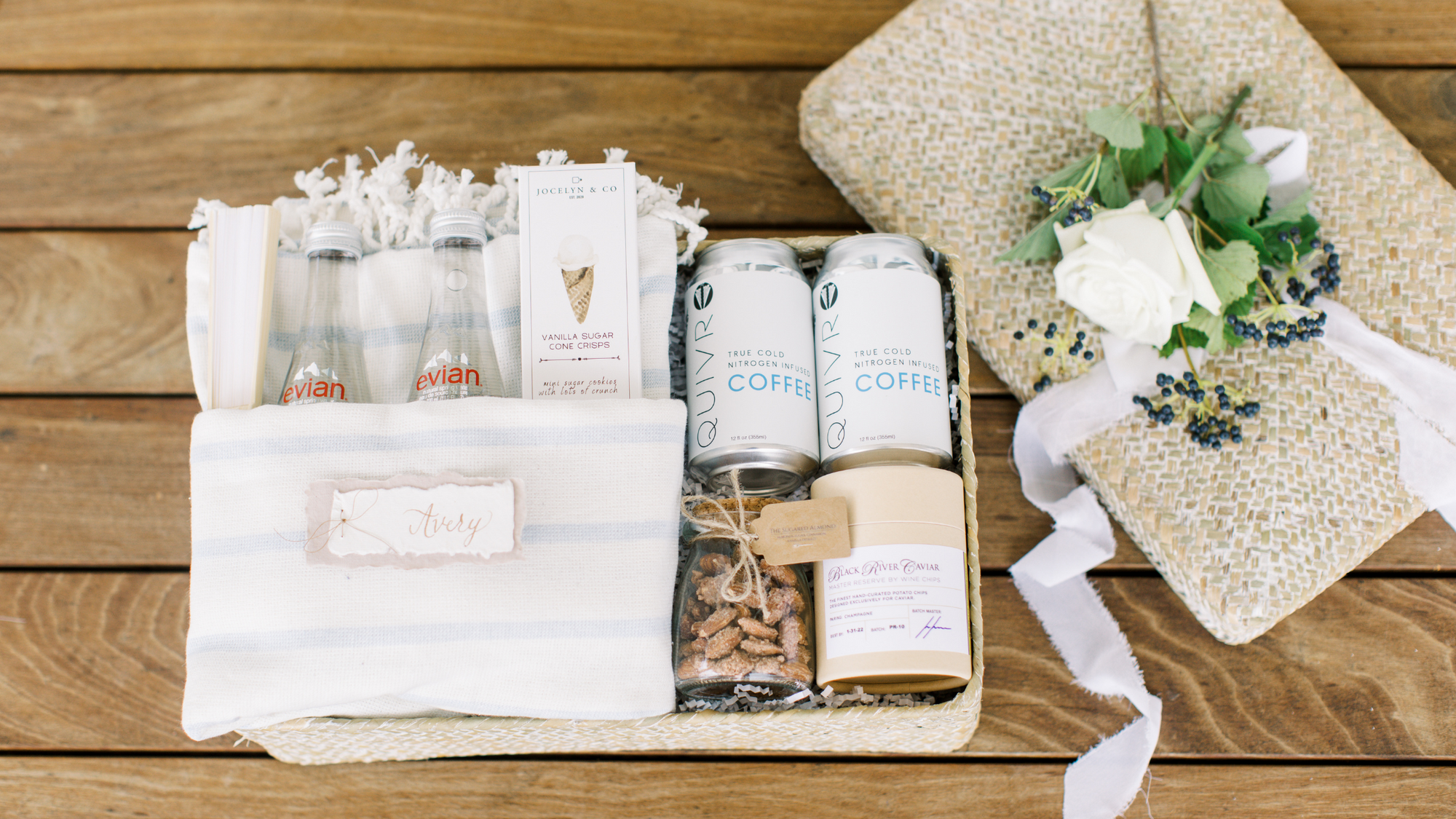 wedding welcome gift bags and boxes for your hotel guests! This beach inspired wedding welcome gifts includes a beach towel, evian water, cold brew coffee, almonds, gourmet chips and beautiful packaging!