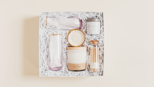 Lavender + Pine gift box with a ring dish, two stemless champagne flutes, Roote Fig Tree candle, rose petal sugar cubes, and a stylish matchbox in a white two piece box.
