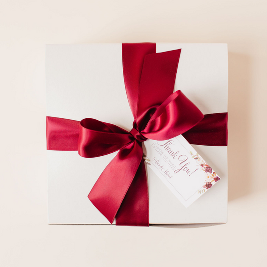 White gift box with burgundy bow and floral gold-rim tag | Lavender + Pine
