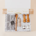 Load image into Gallery viewer, Lavender and Pine Cacio e Pepe Gift Box featuring Bella Cucina bucatini pasta, Le Marké olive oil, Natural OliveWood salt and pepper mills, pasta spoon, La Boite grey salt and Tellicherry pepper, and Kaf Home grey linen napkins in white magnetic gift box
