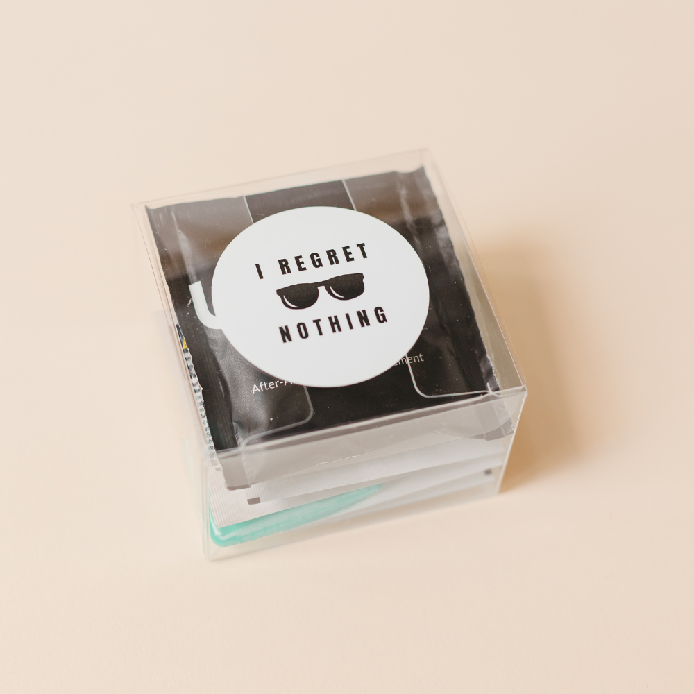 Hangover recovery kit with I Regret Nothing label in clear box