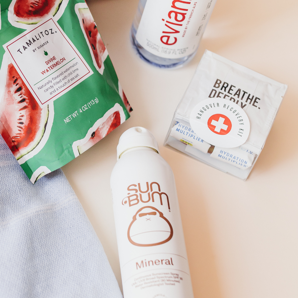 Hangover kit styled with snacks, water, and sunscreen for summer events