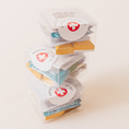 Load image into Gallery viewer, Hangover recovery kits stacked tall in clear acrylic boxes
